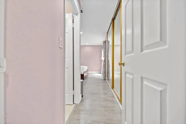a view of a bathroom from a hallway