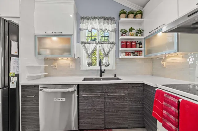 a kitchen with stainless steel appliances granite countertop a sink and a window
