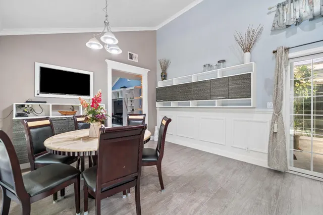 a view of a dining room with furniture window and wooden floor