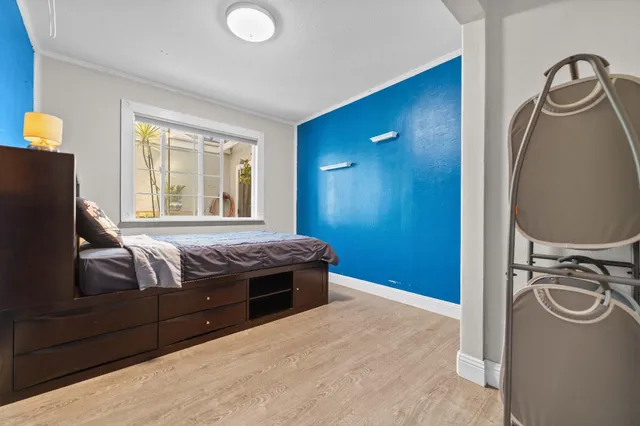 a bedroom with a bed and a mirror