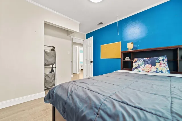 a bedroom with a bed and a view of bathroom