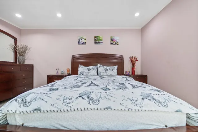 a bedroom with a bed and a dresser