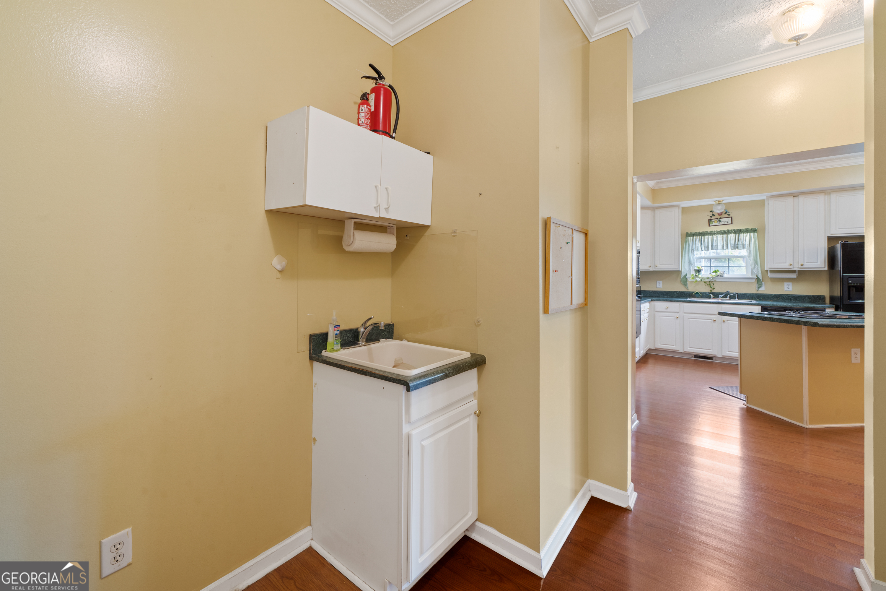 621 Highway 22 Sparta, GA 31087 - Photo 21 of 42 a kitchen with stainless steel appliances granite countertop white cabinets and wooden floor