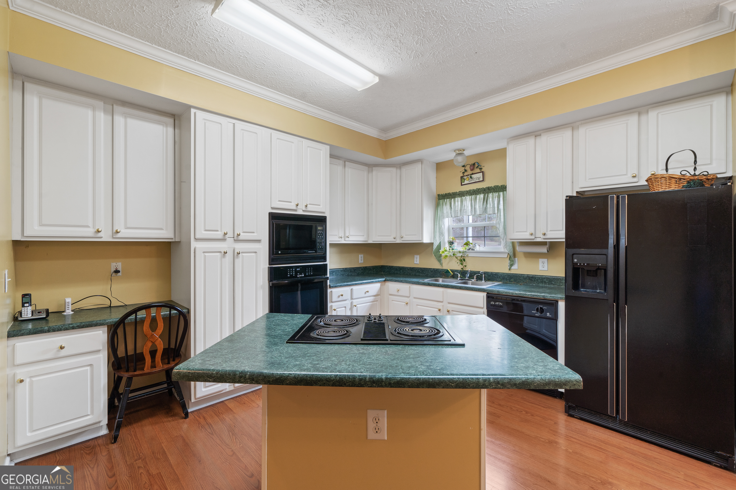 621 Highway 22 Sparta, GA 31087 - Photo 26 of 42 a kitchen with kitchen island granite countertop a refrigerator stove microwave and sink