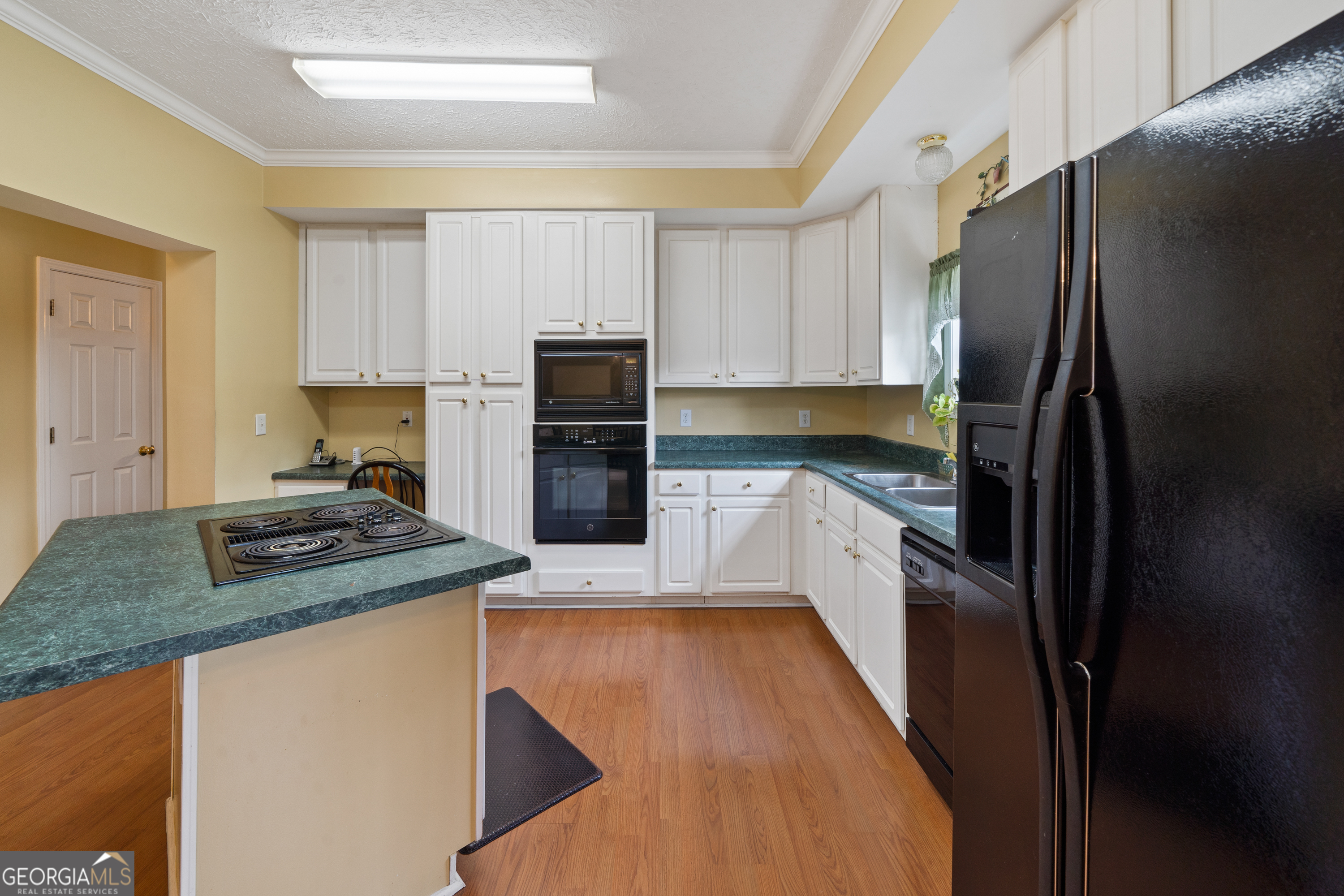 621 Highway 22 Sparta, GA 31087 - Photo 27 of 42 a kitchen with a refrigerator sink and stove