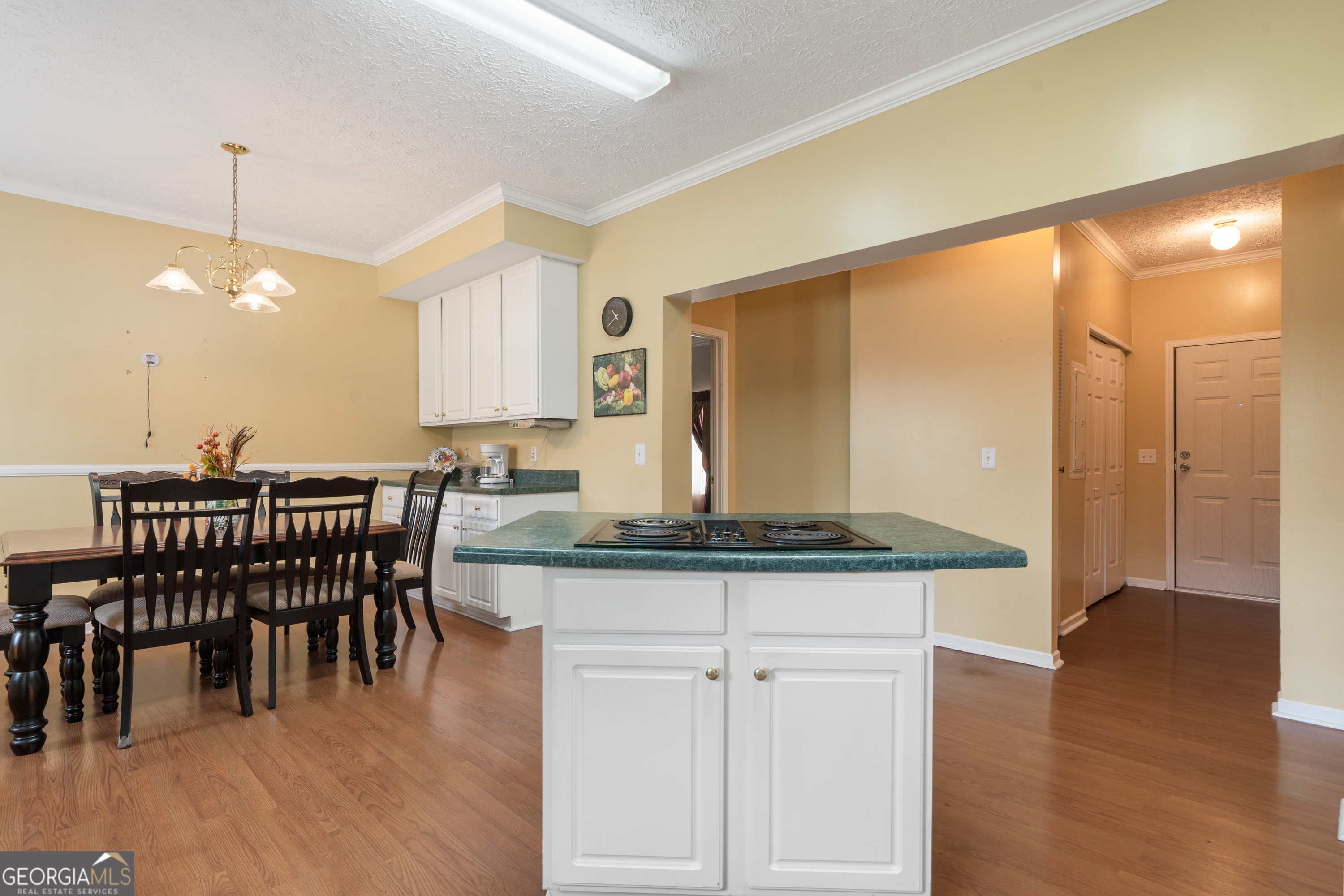 621 Highway 22 Sparta, GA 31087 - Photo 28 of 42 a kitchen with stainless steel appliances granite countertop a table chairs sink and wooden floor