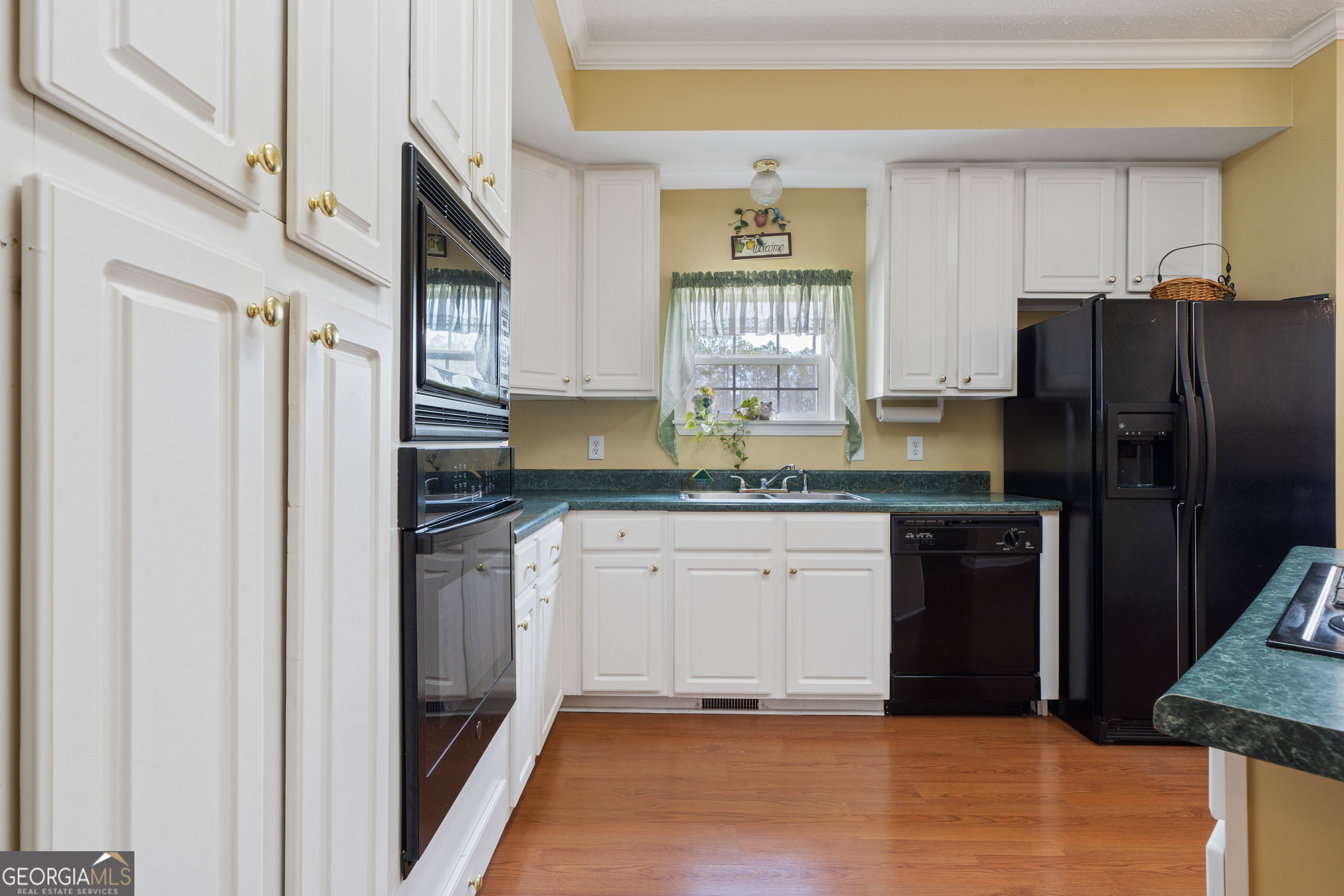 621 Highway 22 Sparta, GA 31087 - Photo 29 of 42 a kitchen with granite countertop a refrigerator and a sink