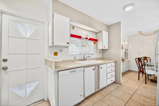 a utility room with sink dryer and washer
