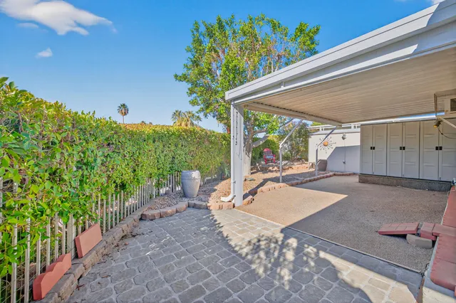 a view of a patio with table and chairs and potted plants