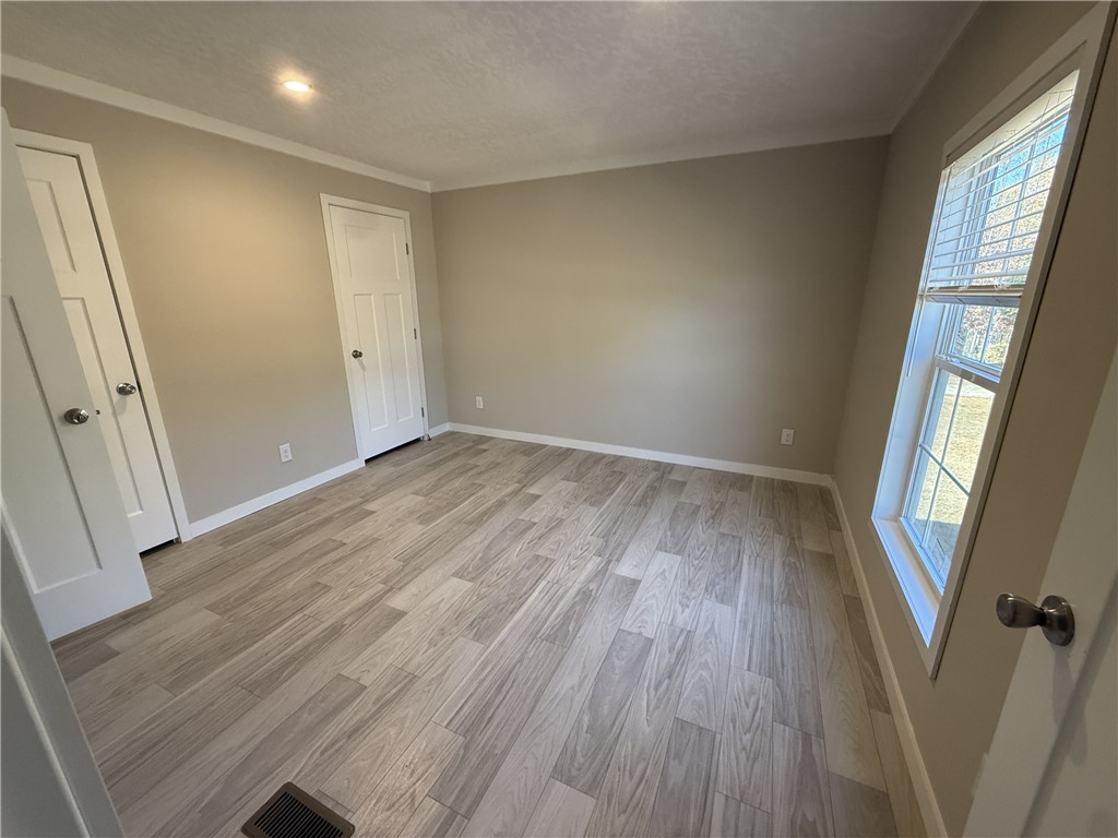 108 Candlestick Lane Seneca, SC 29678 - Photo 9 of 14 The bedroom offers neutral tones, a large window, and durable flooring for peaceful living.