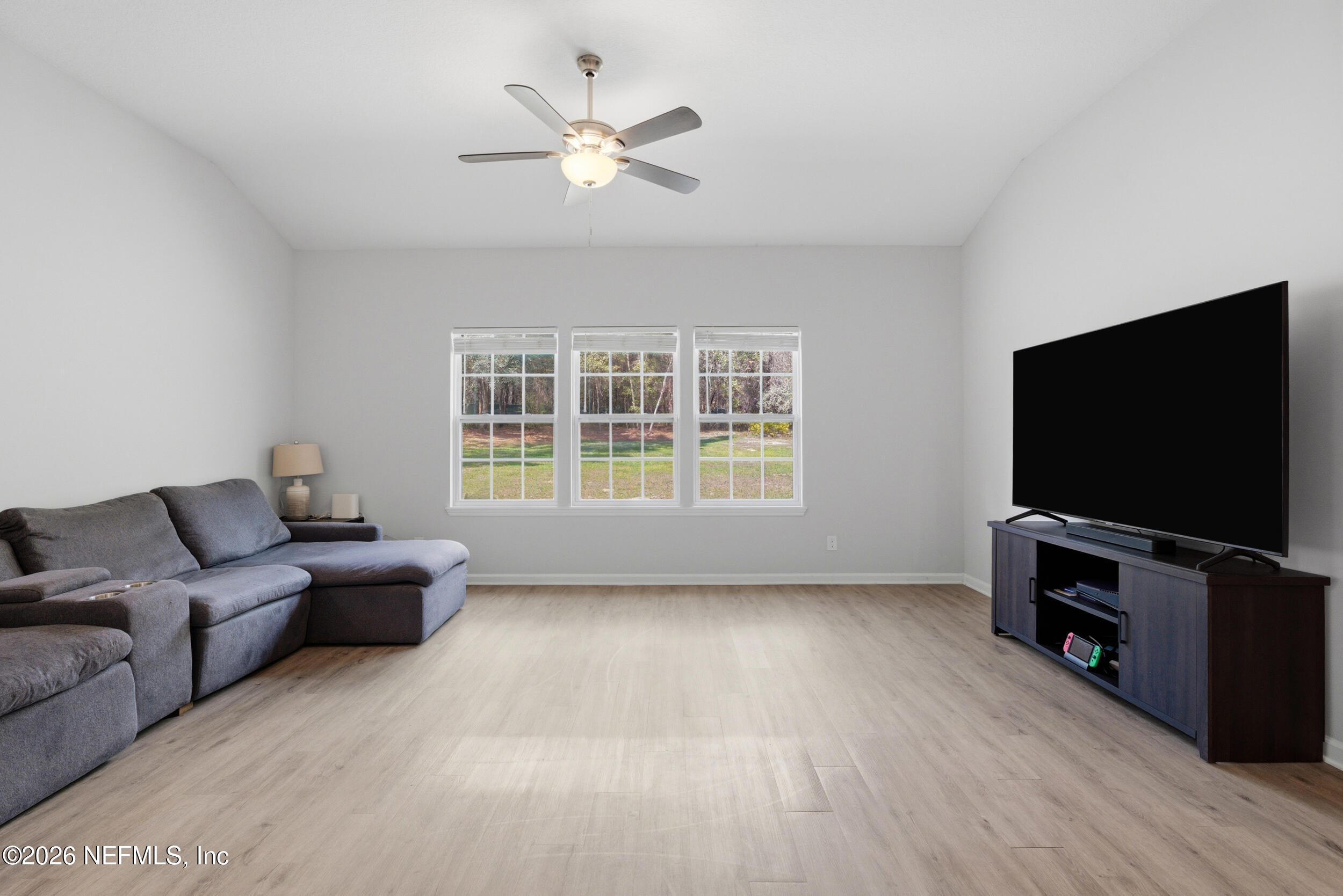 94 Sorrel Street Middleburg, FL 32068 - Photo 25 of 40 a living room with furniture and a flat screen tv