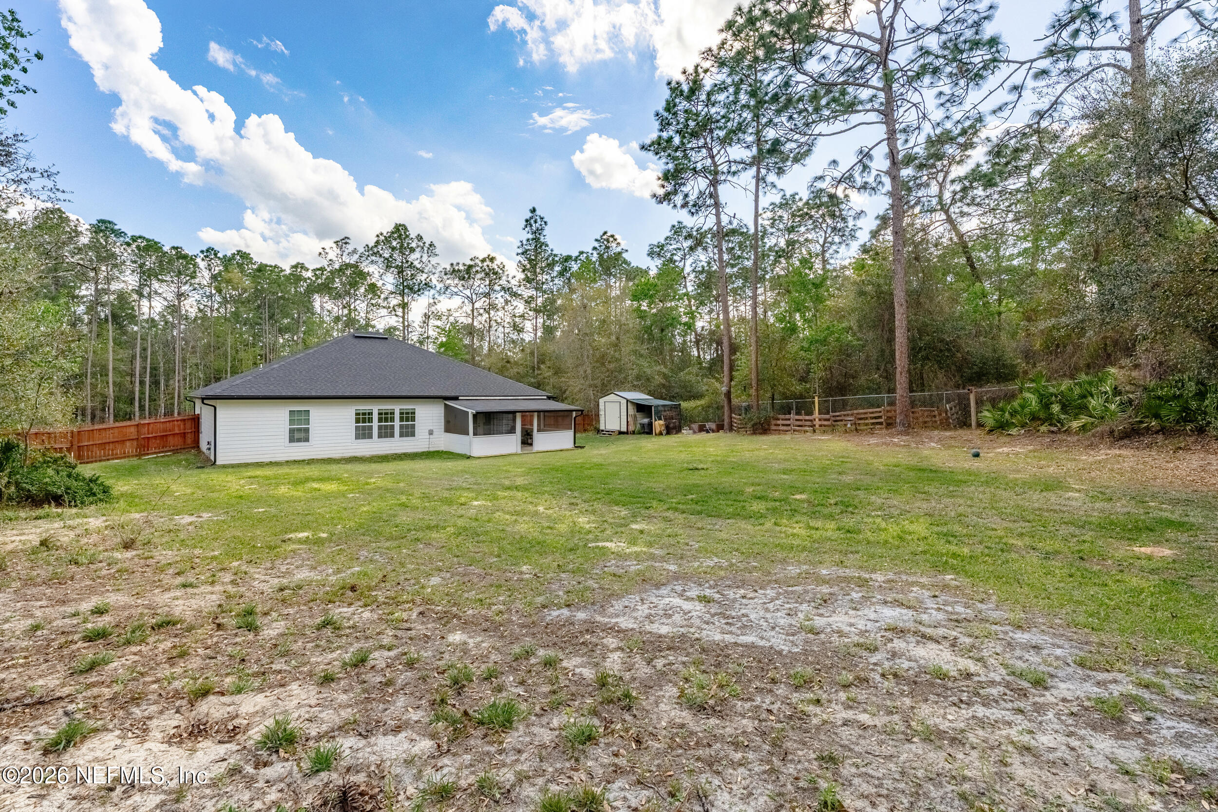 94 Sorrel Street Middleburg, FL 32068 - Photo 30 of 40 a view of a house next to a big yard with large trees