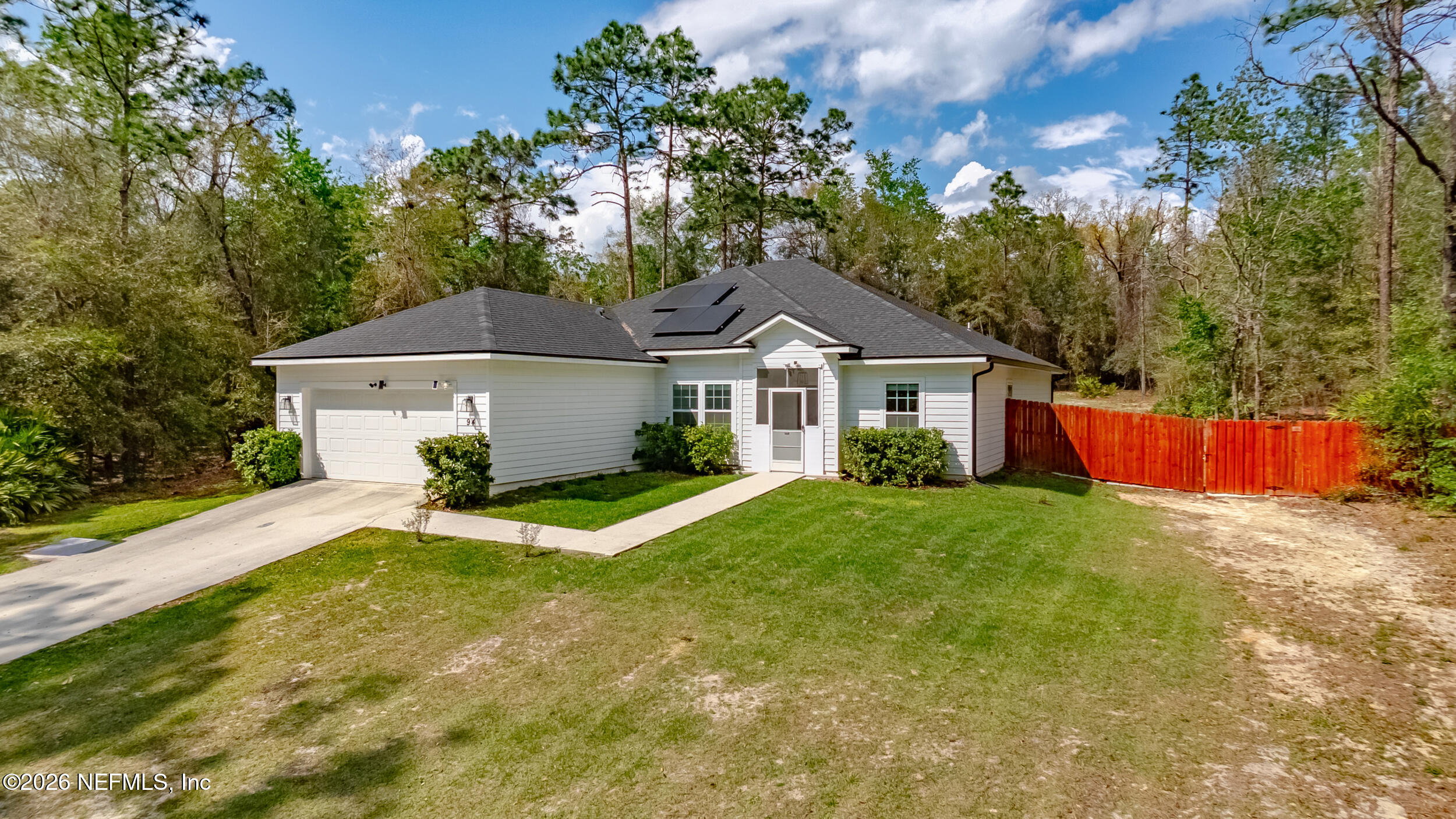 94 Sorrel Street Middleburg, FL 32068 - Photo 33 of 40 a front view of a house with a yard and garage