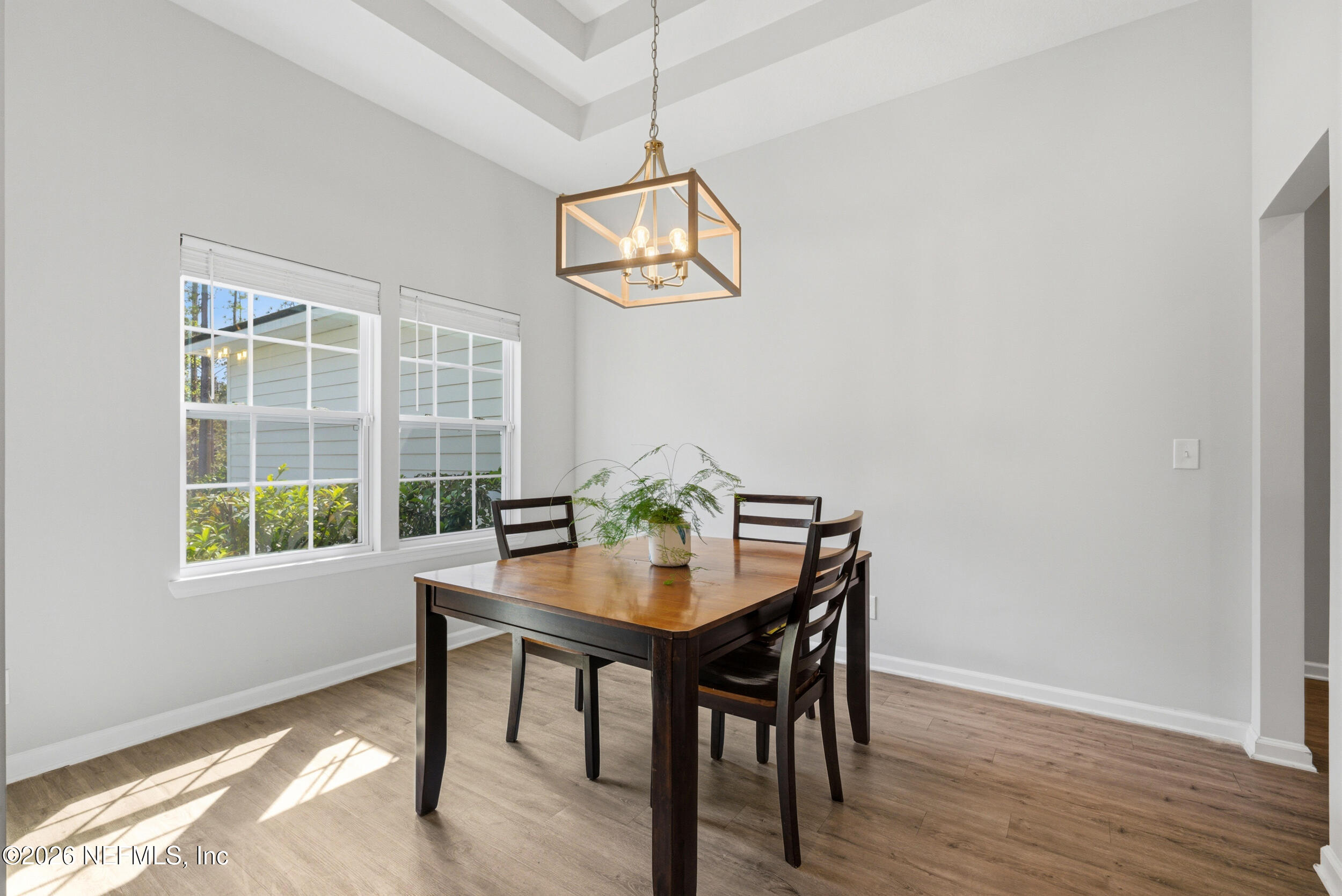 94 Sorrel Street Middleburg, FL 32068 - Photo 7 of 40 a dining room with wooden floor and a chandelier