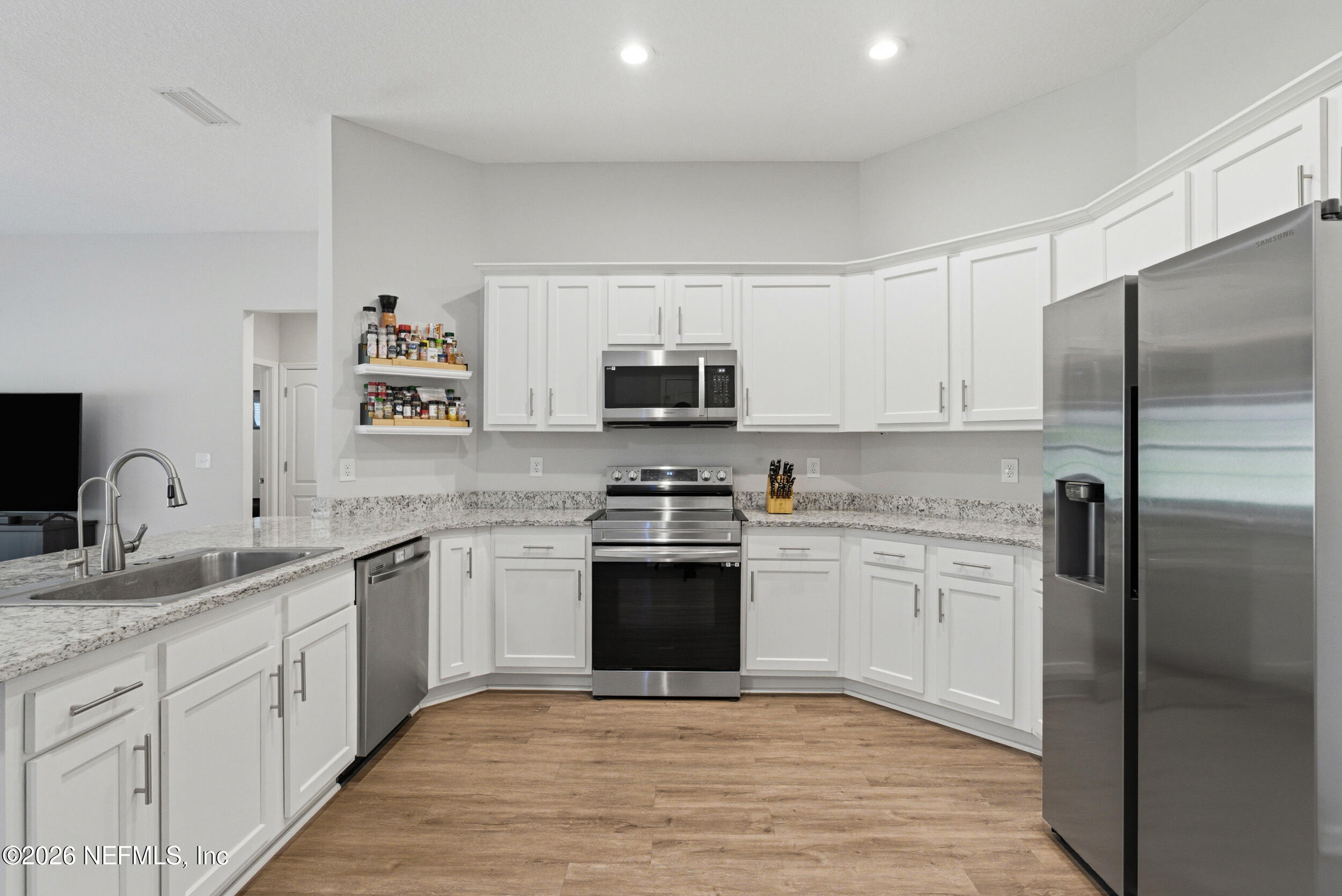 94 Sorrel Street Middleburg, FL 32068 - Photo 9 of 40 a kitchen with stainless steel appliances granite countertop a refrigerator sink and stove