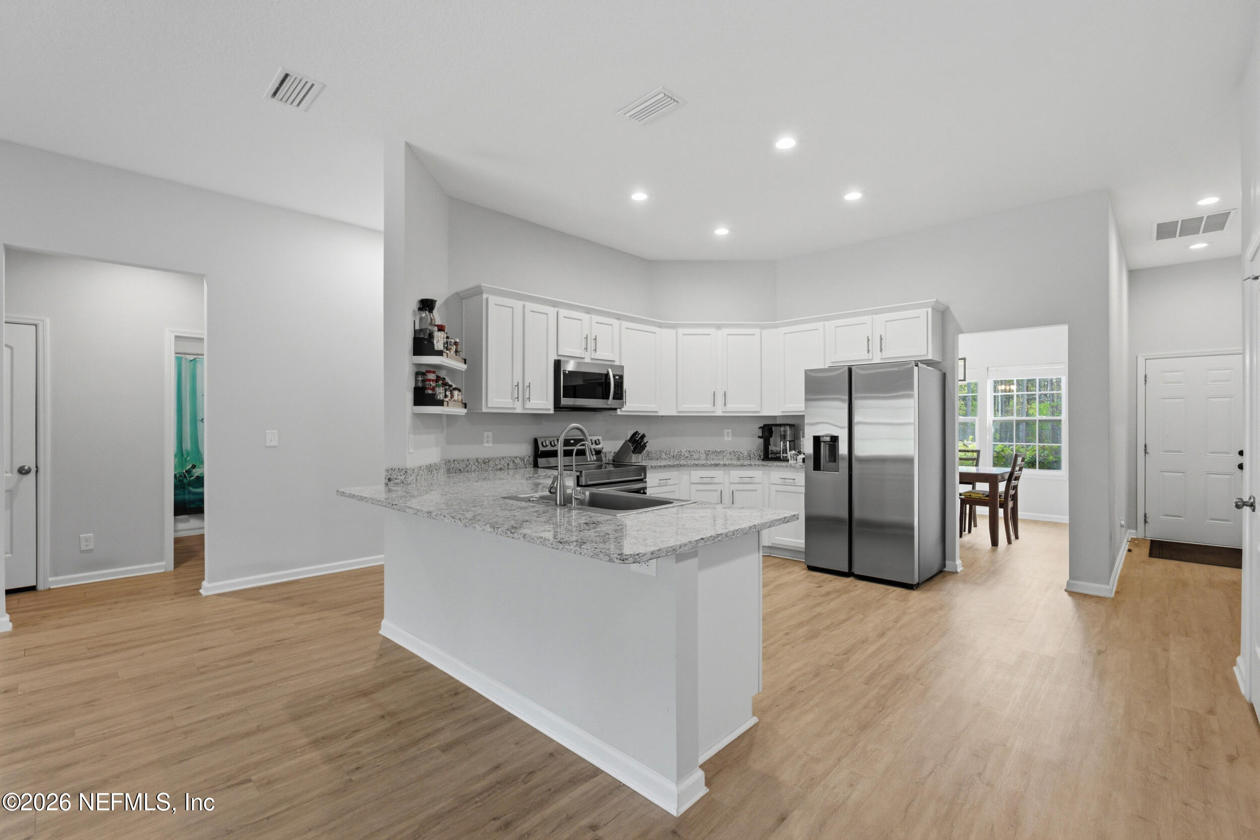 94 Sorrel Street Middleburg, FL 32068 - Photo 10 of 40 a kitchen with stainless steel appliances granite countertop a refrigerator and a stove top oven