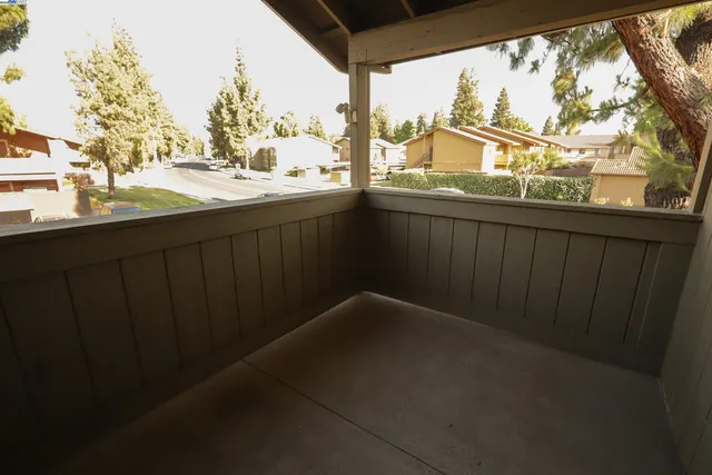 a view of a balcony with wooden fence and floor