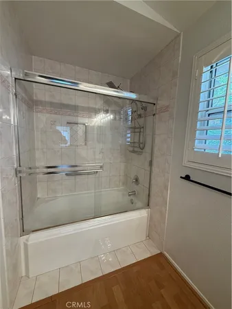 a bathroom with a glass shower door