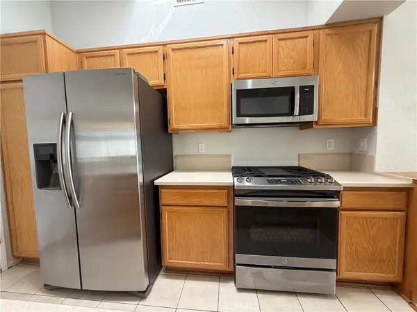 a kitchen with stainless steel appliances white cabinets and a stove