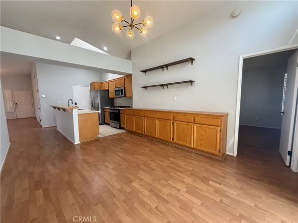 a large kitchen with cabinets and wooden floor