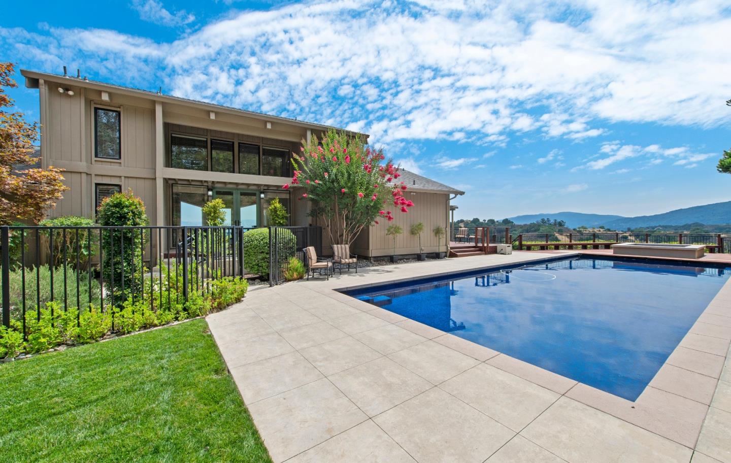 a view of a house with a swimming pool and sitting area