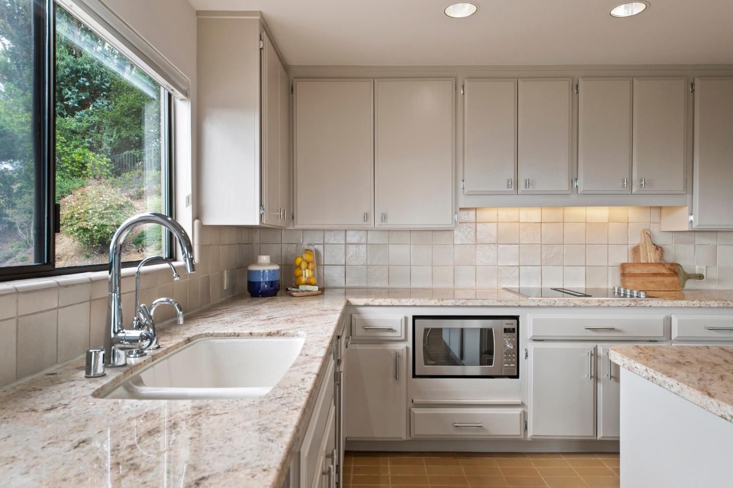 22365 Regnart Road Cupertino, CA 95014 - Photo 18 of 54 a kitchen with granite countertop a sink a stove and cabinets