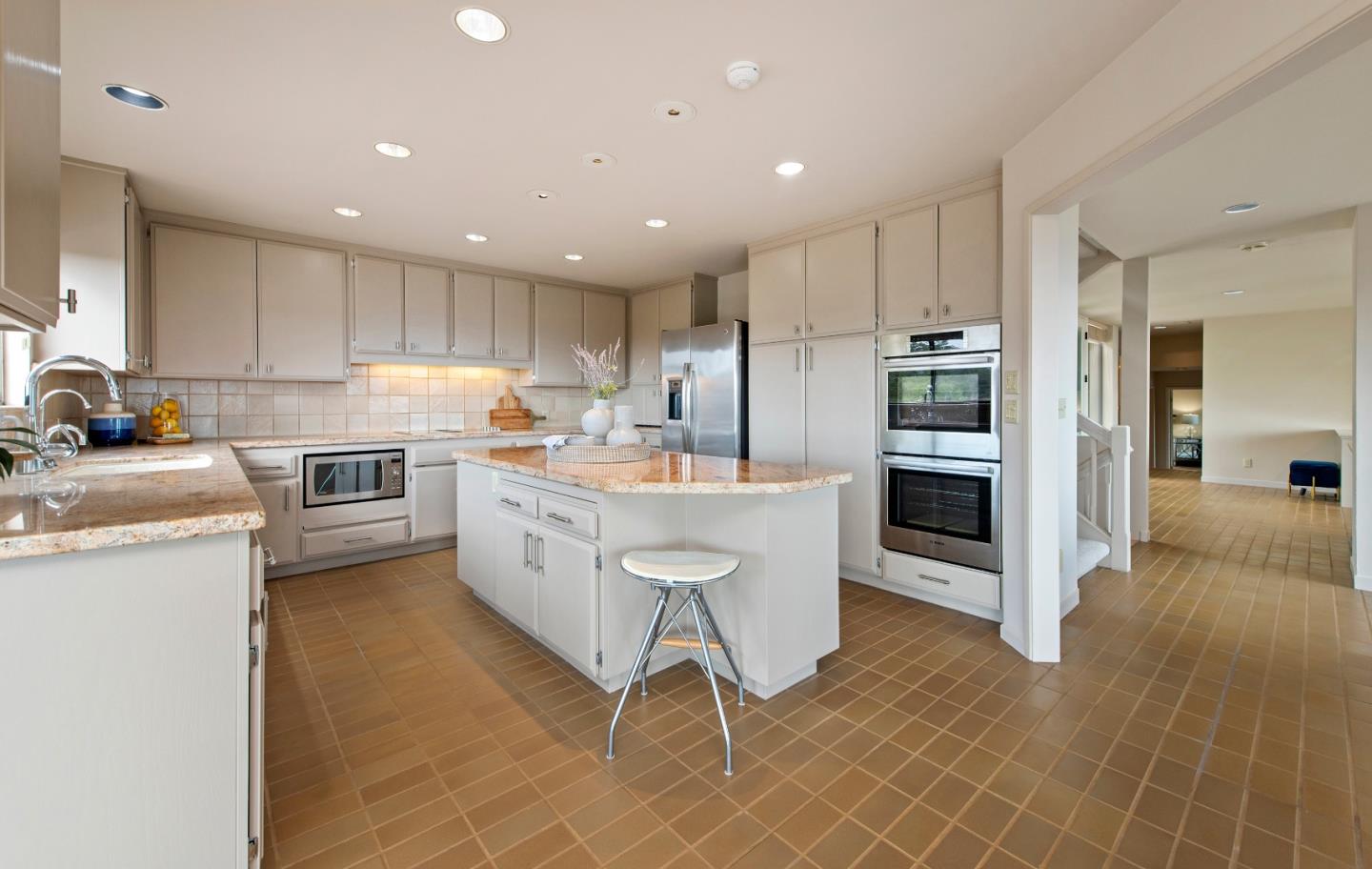 22365 Regnart Road Cupertino, CA 95014 - Photo 20 of 54 a kitchen with stainless steel appliances kitchen island granite countertop a sink refrigerator and cabinets
