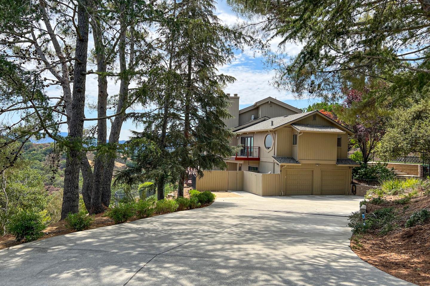 22365 Regnart Road Cupertino, CA 95014 - Photo 2 of 54 a front view of a house with a yard and garage