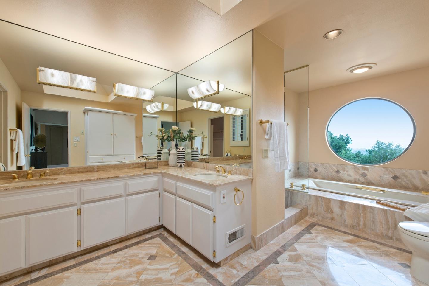 22365 Regnart Road Cupertino, CA 95014 - Photo 26 of 54 a bathroom with a sink a toilet and a mirror