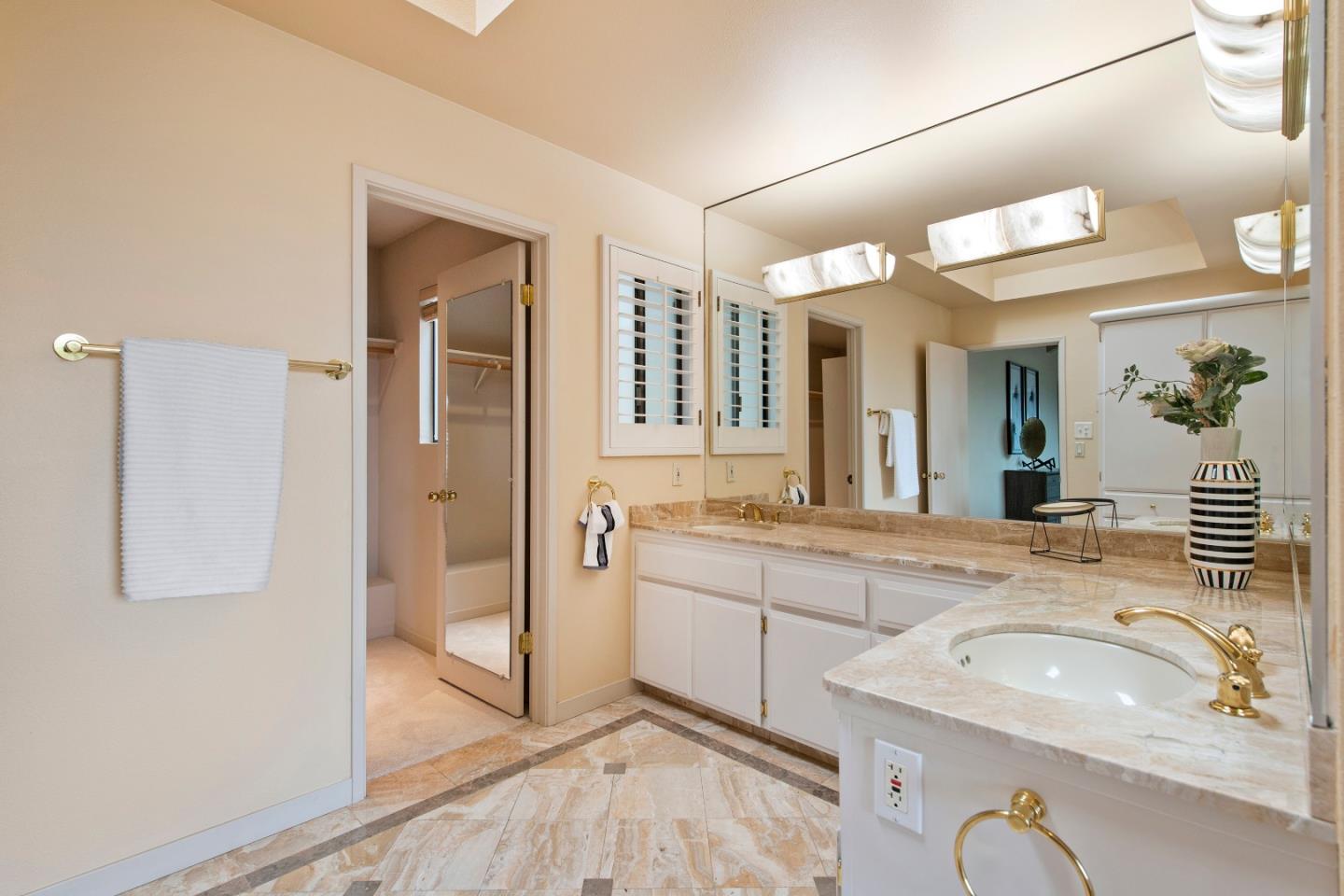 22365 Regnart Road Cupertino, CA 95014 - Photo 28 of 54 a spacious bathroom with a granite countertop sink a mirror and shower