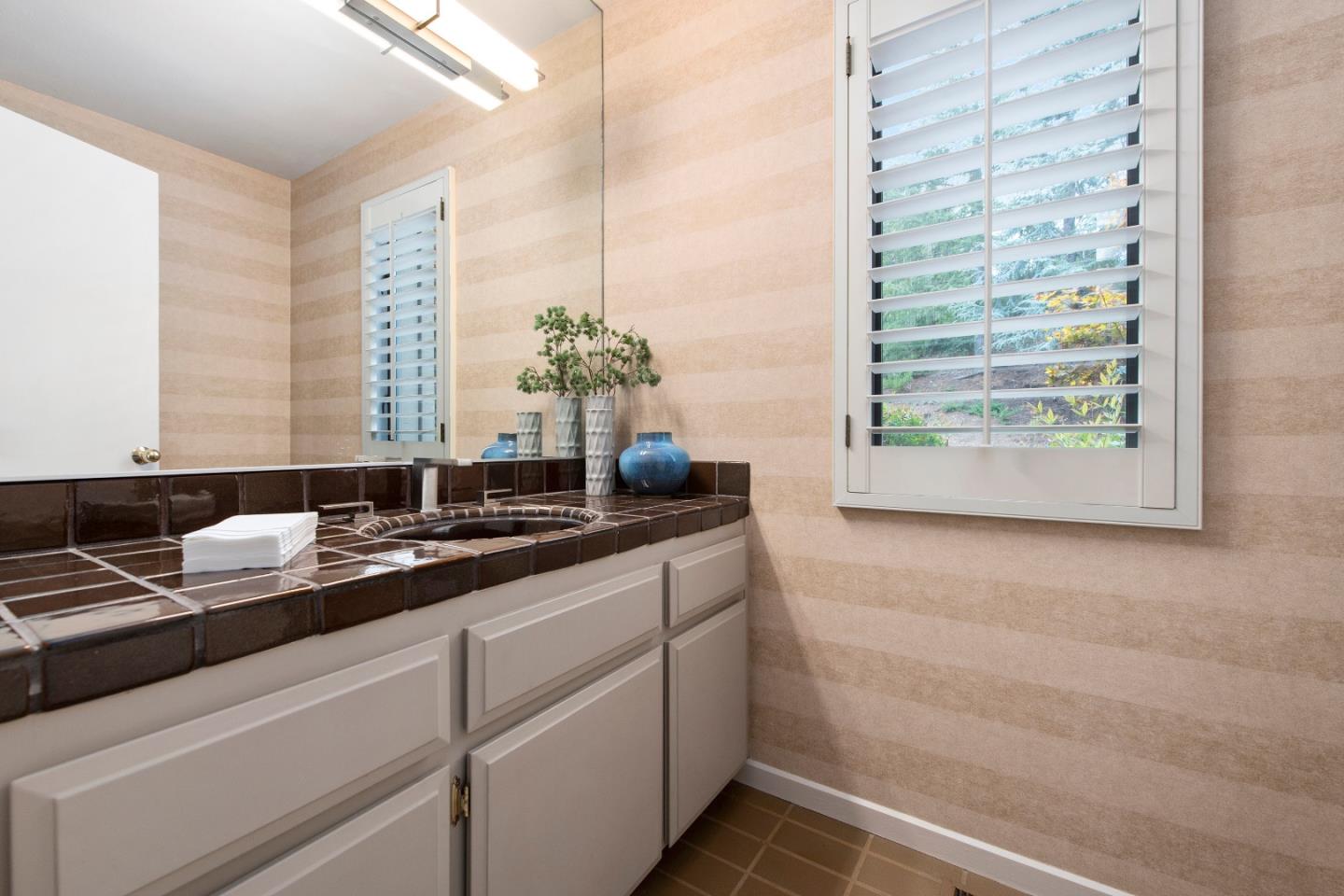 22365 Regnart Road Cupertino, CA 95014 - Photo 32 of 54 a bathroom with a sink and a mirror