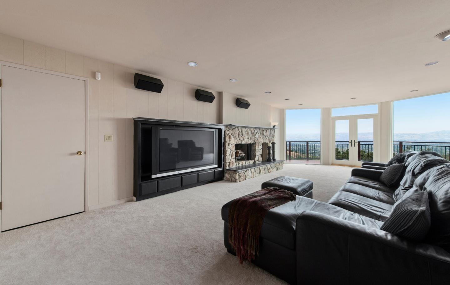 22365 Regnart Road Cupertino, CA 95014 - Photo 33 of 54 a living room with furniture a flat screen tv and a fireplace