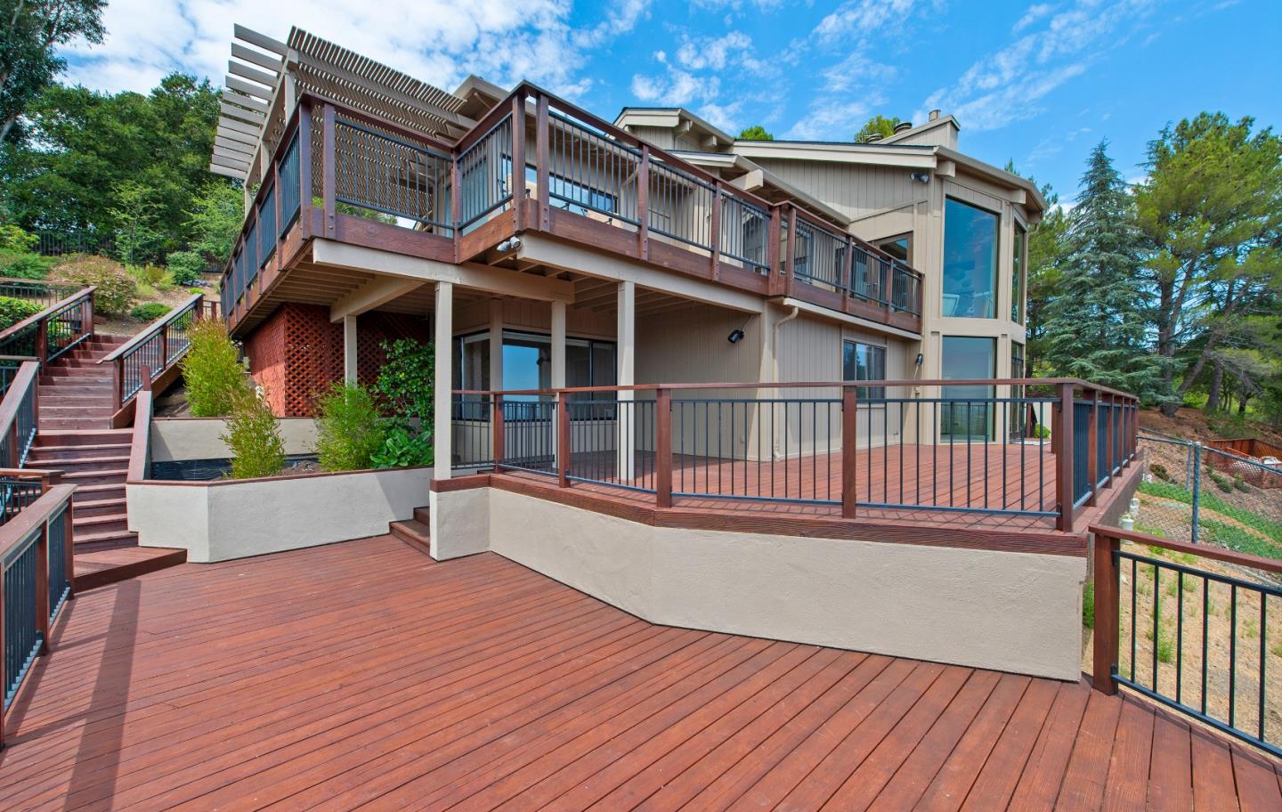 22365 Regnart Road Cupertino, CA 95014 - Photo 49 of 54 a view of a house with a deck