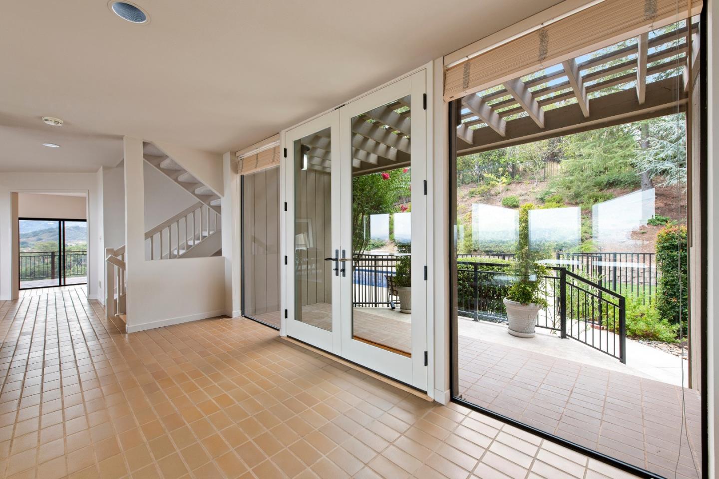 22365 Regnart Road Cupertino, CA 95014 - Photo 6 of 54 a view of a big room with wooden floor and windows