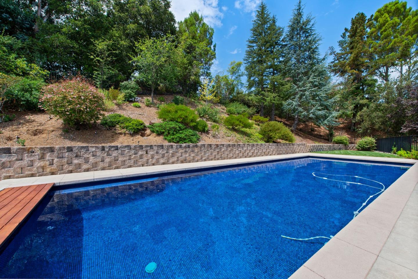 22365 Regnart Road Cupertino, CA 95014 - Photo 8 of 54 a view of a swimming pool with an outdoor space