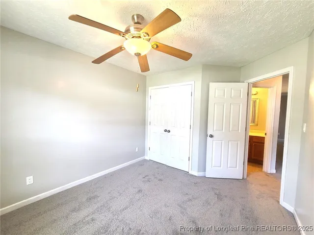 wooden floor in an empty room and a ceiling fan