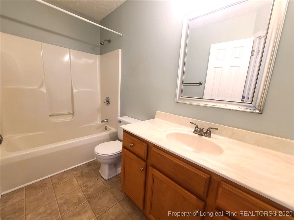 6521 Applewhite Road Fayetteville, NC 28304 - Photo 14 of 22 a bathroom with a sink a toilet and shower
