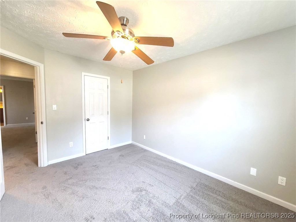 6521 Applewhite Road Fayetteville, NC 28304 - Photo 15 of 22 an empty room with windows and fan