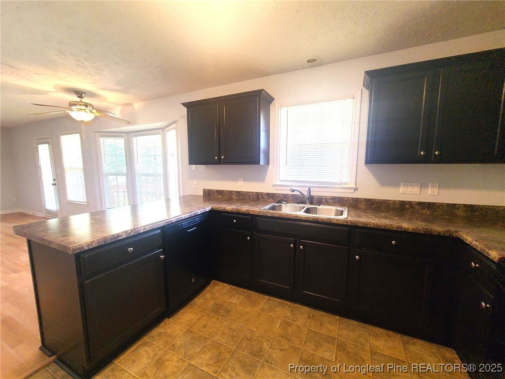 6521 Applewhite Road Fayetteville, NC 28304 - Photo 8 of 22 a kitchen with granite countertop a sink and a stove