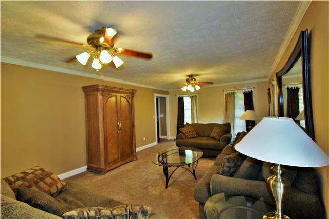 1051 Academy Road Lebanon, TN 37087 - Photo 17 of 20 a living room with furniture a dining table and a chandelier