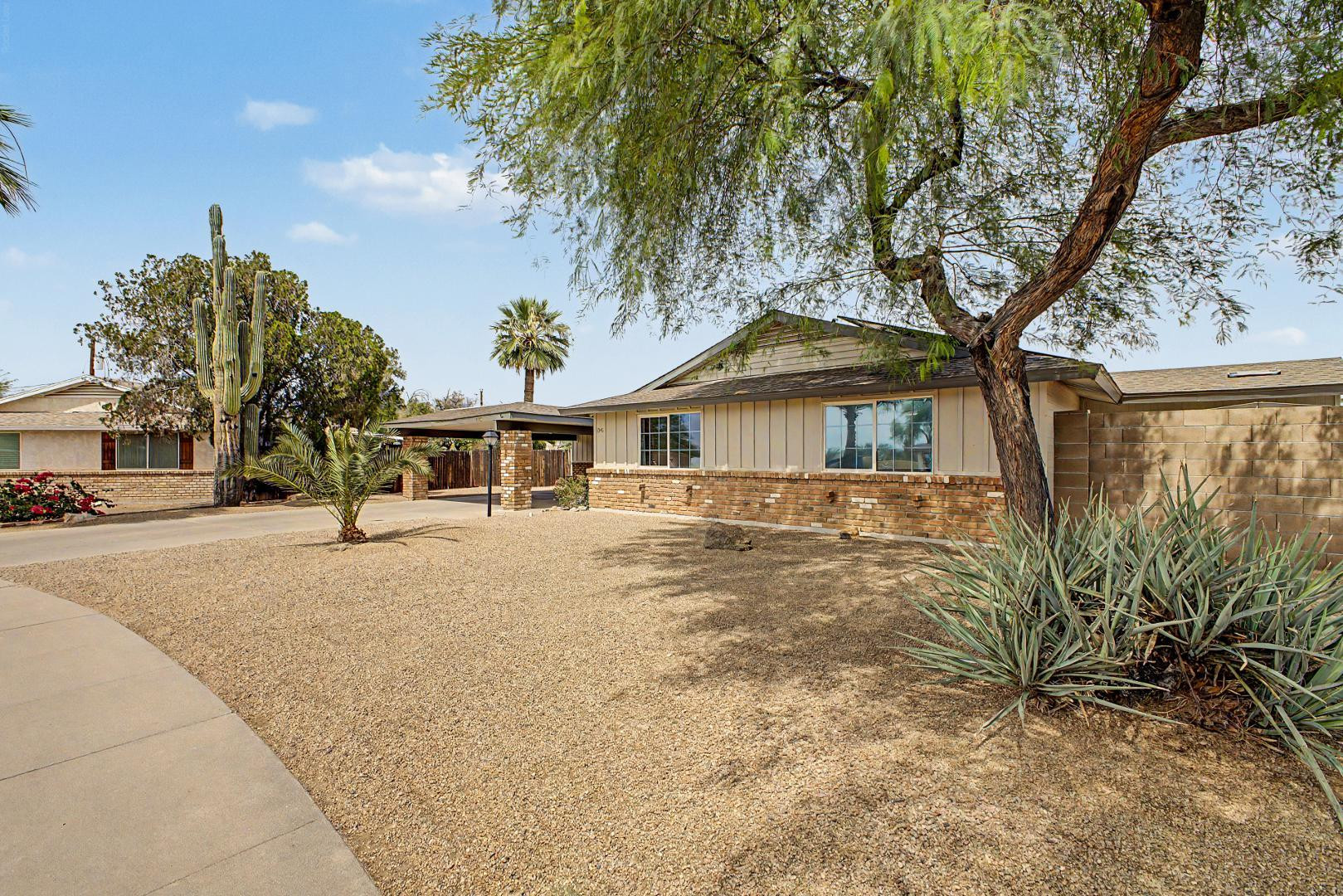 3346 East Cochise Road Phoenix, AZ 85028 - Photo 2 of 40 a front view of a house with a garden