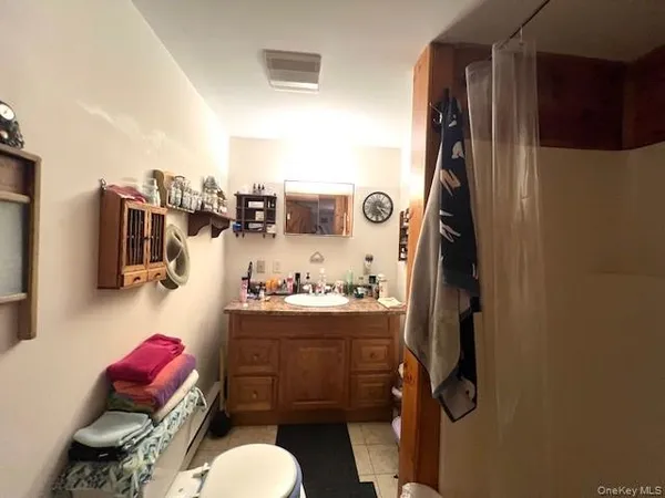 a bathroom with a sink mirror vanity and toilet