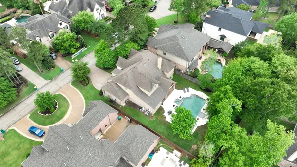 an aerial view of a house with a yard and garden