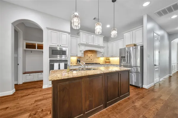 a big room with closet and a chandelier fan