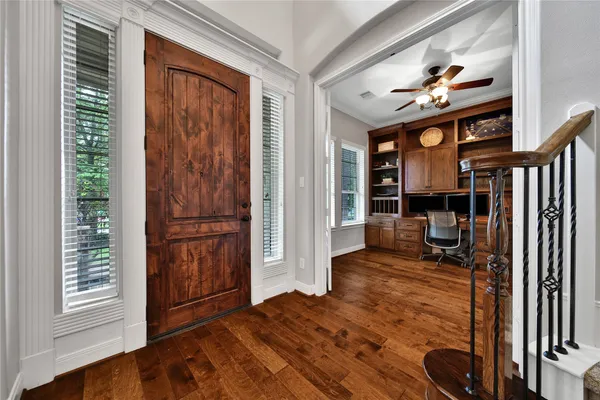 a large kitchen with granite countertop a large counter top space stainless steel appliances and wooden floor