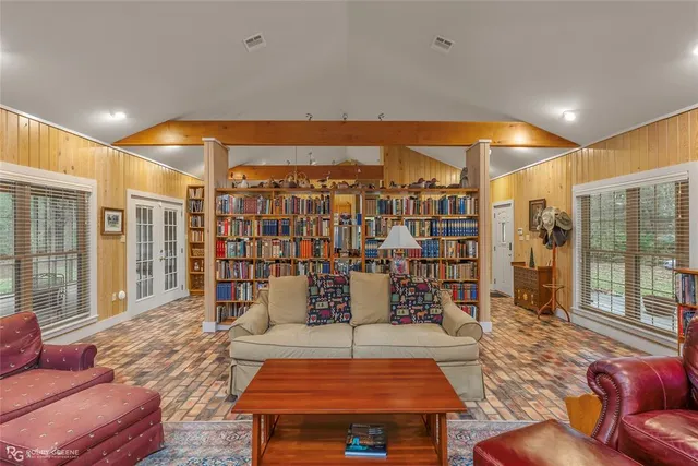 a living room with furniture and a floor to ceiling window