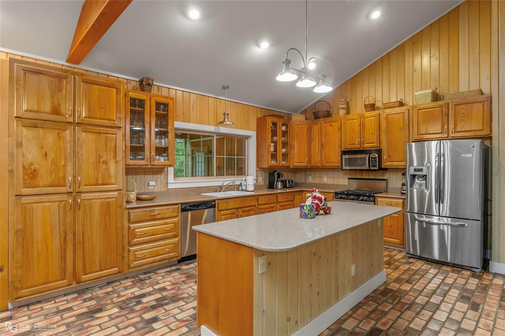 3100 Herren Road Doyline, LA 71023 - Photo 14 of 40 a kitchen with stainless steel appliances granite countertop a sink refrigerator and cabinets