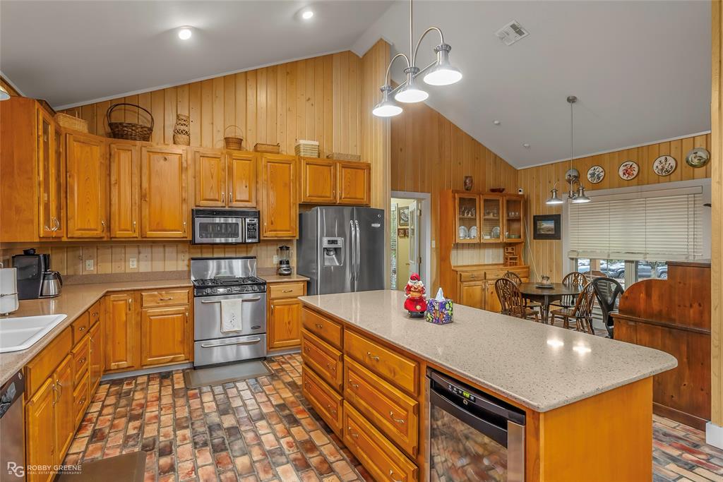 3100 Herren Road Doyline, LA 71023 - Photo 16 of 40 a kitchen that has a lot of cabinets a sink and appliances in it