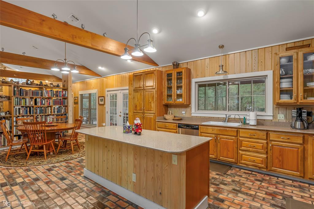 3100 Herren Road Doyline, LA 71023 - Photo 17 of 40 a view of a kitchen with a dining table chairs and sink
