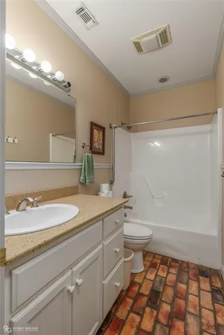 a bathroom with a sink a toilet a mirror and shower